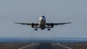 Front view of an airplane taking off from runway